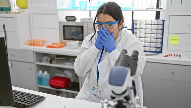 Shocked young hispanic woman scientist, covering her mouth with hands in sheer horror after making a mistake at the lab - a beautiful secret brewing in the midst of chaos.