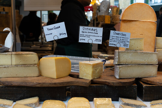 LONDON, ENGLAND, UK - February 24, 2024: A small selection of cheese displayed with labels and price labels at a stall in Borough Market in London.