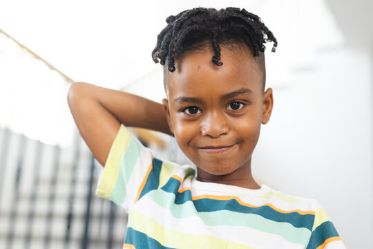 African American boy with a playful smile, wearing a striped shirt