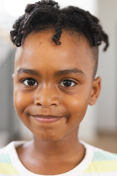 African American boy with a cheerful smile, wearing braids