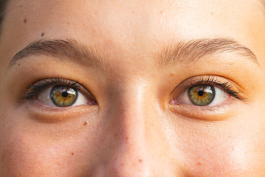 Close-up of a young Caucasian woman's eyes on a hike, showcasing hazel irises