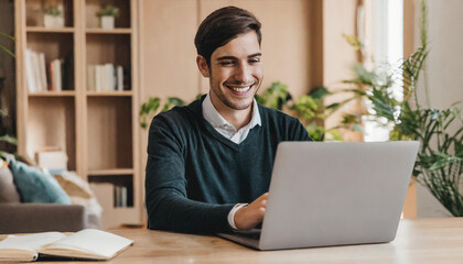 Fototapeta premium man working on laptop; businessman smiling and working on laptop at home; homeoffice