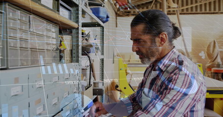 Image of data processing over caucasian male carpenter working in workshop