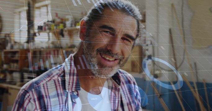 Image of data processing over caucasian male carpenter working in workshop