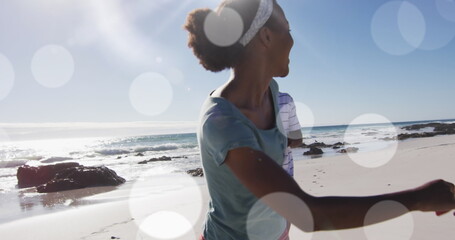 Image of spots over african american couple at beach