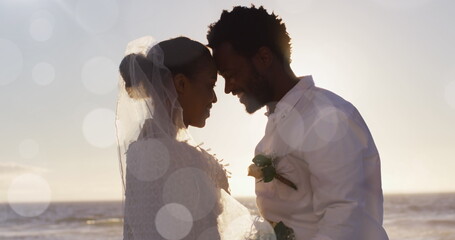 Image of dots over happy african american newly married couple on beach