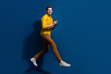 Fototapeta na wymiar Full body photo of attractive guy instagram twitter facebook telegram wear trendy yellow clothes isolated on dark blue color background
