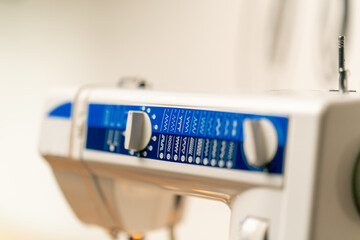 close-up in a sewing workshop on machine showing possible stitch patterns