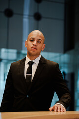 African american businessman looking at camera on reception of business center