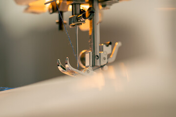close-up in a sewing workshop thread is inserted into a needle on a machine
