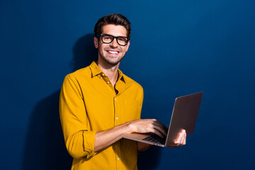 Photo portrait of nice young male hold netbook specs smm manager dressed stylish yellow garment...