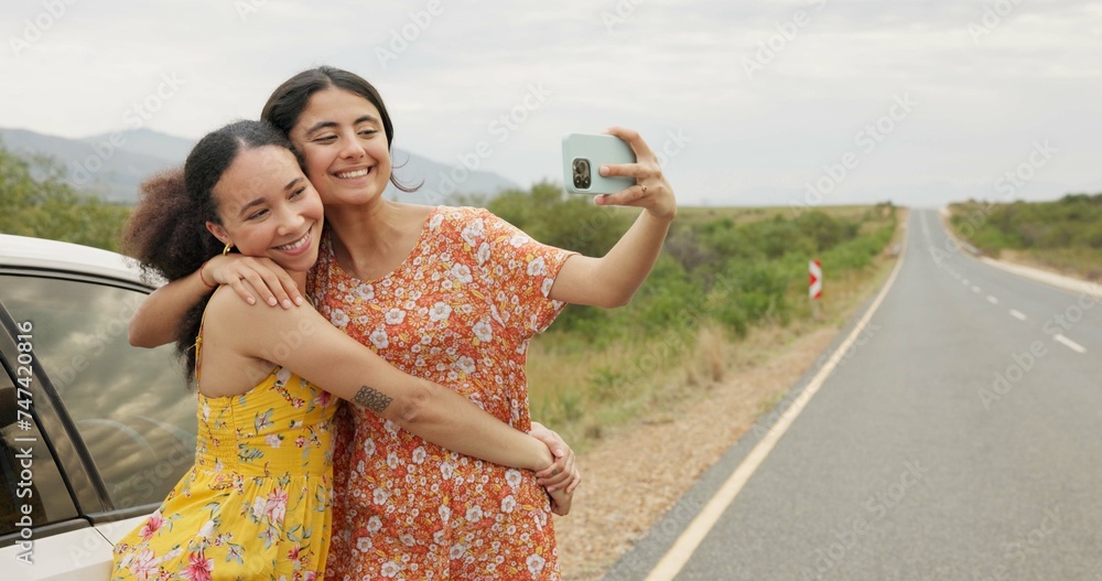 Wall mural Women, friends and selfie by car on road trip with memory, profile picture and happy with kiss in countryside. Girl, photography and together with hug, bonding and care for post on social network