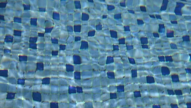 slow motion video of pool bottom with blue and light blue veins with water movement