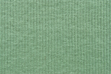 Soft green color ribbed jersey fabric pattern close up as background
