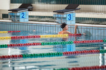Portrait of a woman, a professional swimmer in the athletic pool