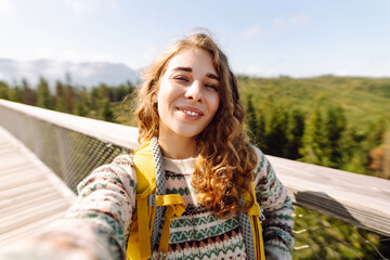 Happy tourist walking and takes selfie using smartphone camera. Lifestyle, travel, tourism, active...