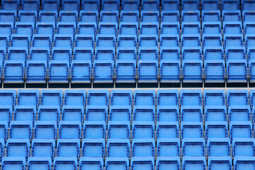 blue plastic spectator seats in a football stadium