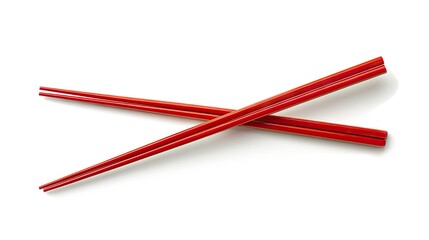 Pair of red chopsticks isolated on white, representing the essence of Asian dining culture.