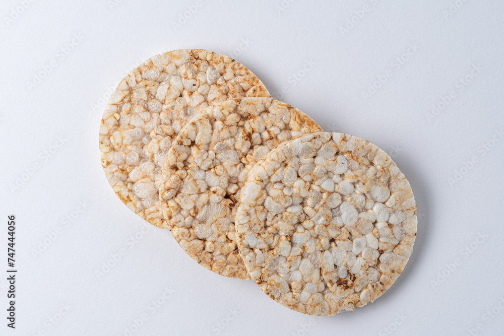 Wall mural Pile of three rice cakes on white backdrop. Food background.