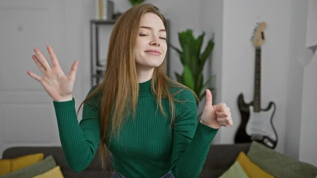 Blonde bombshell beaming! young woman, all smiles, confidently points up, showing the number six with her fingers at her cozy home