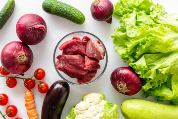 Keto diet food background. Raw beef meat and vegetables for cooking