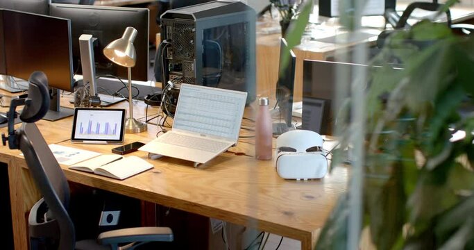 A modern business office desk setup with multiple screens and gadgets