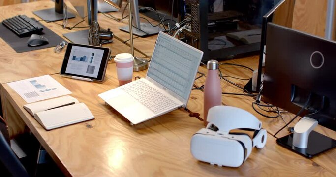 A modern business office desk is equipped with various tech gadgets