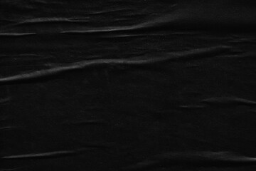 Dark black creased crumpled paper background surface old posters grunge texture backdrop surface empty space for text         