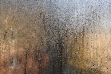 there are drops of water on the glass. condensation on wet glass