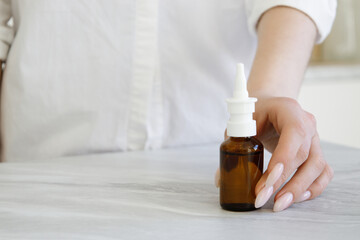 cold spray, a concept for treating colds or flu. Girl takes a nasal spray, copy  space