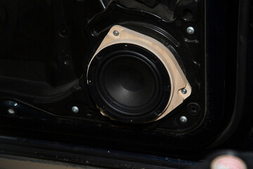 Installing a car speaker system in the door.The installation center. Detaling car center.