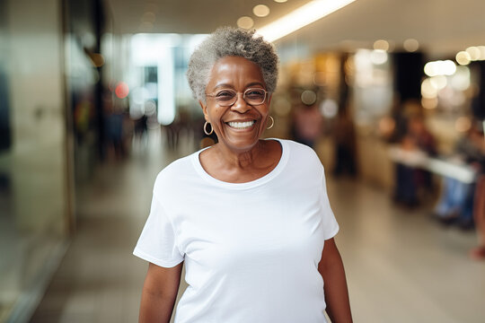 Portrait of a smiling afro senior woman in eyeglasses standing in the shopping center. Mock-up for design. Blank template.