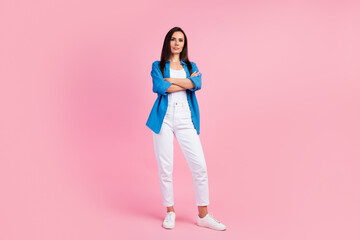 Full size photo of serious confident strict girl dressed blue shirt white trousers keep palms folded isolated on pink color background