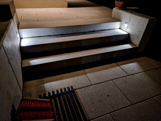 lighting of stairs and steps on the concrete wall on the side of the stairs. recessed reflectors...