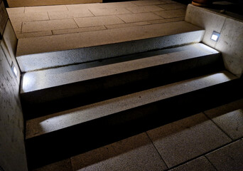 lighting of stairs and steps on the concrete wall on the side of the stairs. recessed reflectors...