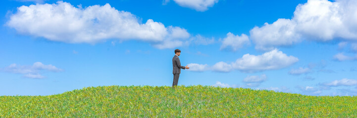 Solitude in Serenity: Man in Suit Standing Alone on a Lush Green Hill Under Blue Sky