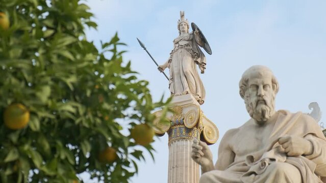 Athena column with statue of Plato and tangerine tree from the Academy of Athens, Greece. Selective focus. Focus on Athena statue