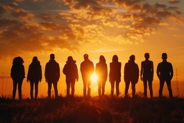 A group of people standing in a field at sunset. Ideal for lifestyle and nature concepts