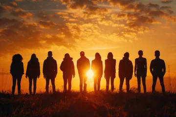  A group of people standing in a field at sunset. Ideal for lifestyle and nature concepts © Fotograf