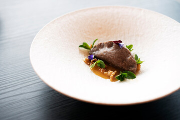 Dessert on white plate with dumpling and caramel