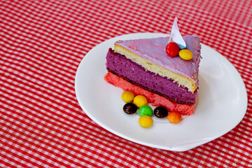 a piece of sponge cake with a cup of strawberry milk on the table