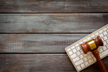 Lawyer desktop with judge gavel and keyboard, top view