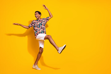 Fototapeta na wymiar Full body length size photo of young funky positive man steps wearing casual summer clothing dance isolated on yellow color background