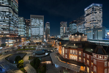 Night view of modern office buildings and historic landmark Tokyo Station in the Marunouchi...