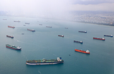 Aerial view of the Singapore Strait, Ocean liner, tanker and Cargo Ship with rain storm in...