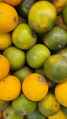 Close up pile of tasty fresh oranges sold at the market as a background.