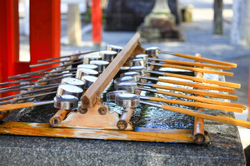 Naklejka premium Japanese metal dipper prepare for people who visit the shrine for clean mouth, hand, face.