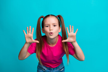Photo of funky crazy girl wearing trendy pink clothes showing palms scaring you saying boo isolated on cyan color background