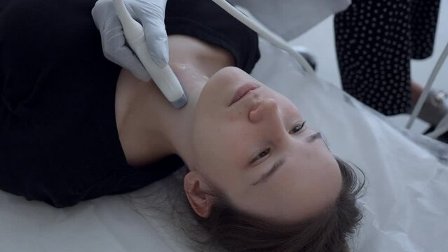 Young man has throat ultrasound. Clip. Teenager has ultrasound of neck and throat to check glands. Problem of developing throat cancer from e-cigarettes and vapes in young people