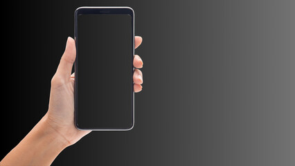 Hand holding cell phone mockup with blank screen. Smartphone mock up isolated on black bacground